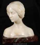 A superb Bust of a young lady in pensive pose, her plaited hair arranged as a band over her brow,