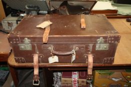 A large leather suitcase with leather straps 28 1/2" long x 16" deep x 9 1/2" high.