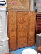 An attractive Mahogany carcassed Triple Wardrobe, the doors having cross-banded burr Walnut veneers,