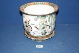 An oriental jardiniere and saucer with panels of soldiers on horse back fighting between