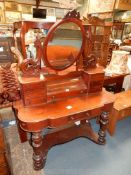 A Duchess type Mahogany Dressing Table, the oval mirror raised on supports with seven small drawers,
