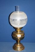 A brass double burner oil lamp with etched and frosted glass globe shade and clear glass chimney,
