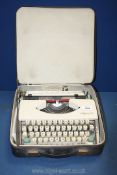 A vintage Olympia De Luxe typewriter with case, zip broken on case.