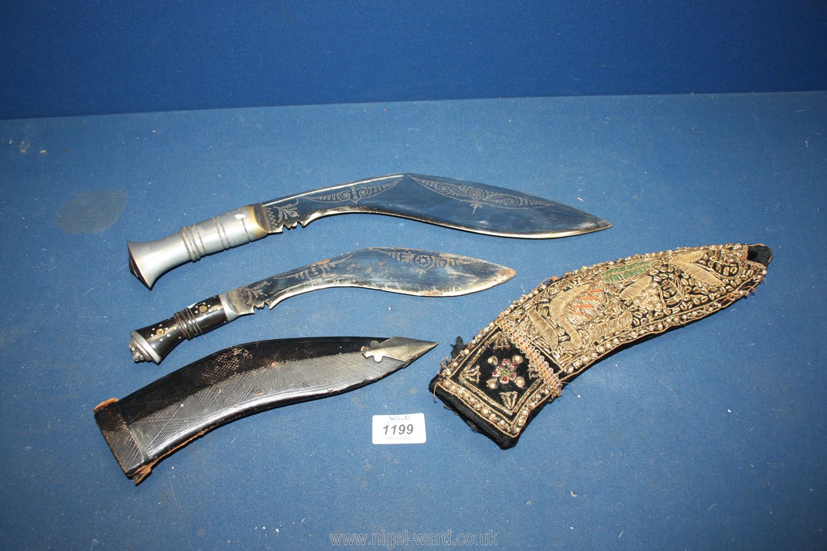 Two ceremonial style daggers marked 'India' to the elaborately decorated blades,