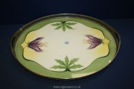 An oval two handled china base Art Nouveau style plated galleried Tray on bun feet with stylised