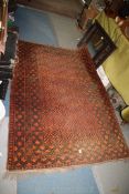 A terracotta and black ground bordered, patterned and fringed Rug, 79'' x 50''.