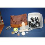 A Fishing bag with fly lines etc. and a box with 3 fixed spool reels including a Mitchell reel.