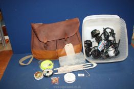 A Fishing bag with fly lines etc. and a box with 3 fixed spool reels including a Mitchell reel.