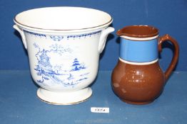 A brown pottery Jug, 6'' tall and a Royal Winton blue and white Ice Bucket, 7'' tall.