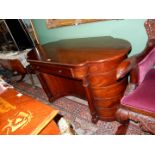 A Mahogany Writing Desk of uncommon design having bowed ends and reverse bowed kneehole flanked by