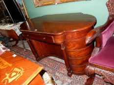 A Mahogany Writing Desk of uncommon design having bowed ends and reverse bowed kneehole flanked by