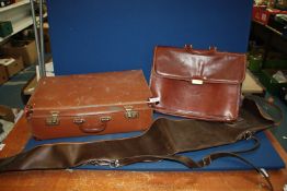 A brown leather suitcase and leather Gladstone bag (with key) plus a gun case.