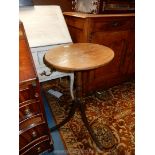 A circular Oak topped occasional Table standing on a slender turned pillar and three swept legs,