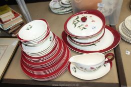 A four place setting Wedgwood dinner service in 'Mayfield' design (one vegetable dish with chip to