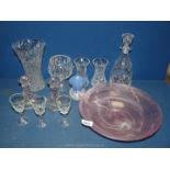 A quantity of glass including vases, decanter, candlesticks, pink swirl bowl, and blue bud vase.