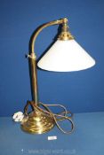 A brass desk lamp with white glass coolie shade, dent to base, 21" tall.
