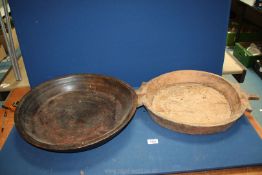 A large shallow wood bowl, possibly for dough, slight oval shaped,