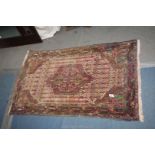 A small Turkish rug, multi-coloured, bordered, patterned and fringed, some wear to the edges,