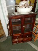 An appealing double doored glazed Cabinet having a pair of short drawers below,