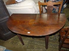 A most unusual and surprisingly heavy Mahogany demi-lune side Table with a rear hinged drop-leaf