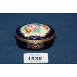 A Trinket box in dark blue with floral and gilt decoration,