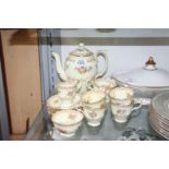 A pretty Crown Staffordshire part Teaset decorated with flowers and gold coloured detail on pale