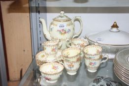 A pretty Crown Staffordshire part Teaset decorated with flowers and gold coloured detail on pale