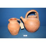 An old terracotta ewer, 10 1/2'' tall (handle repaired) and pottery jug, 7'' tall.