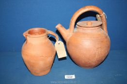 An old terracotta ewer, 10 1/2'' tall (handle repaired) and pottery jug, 7'' tall.