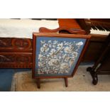 A Mahogany framed Fire screen having a framed tapestry of stylised foliage and flowers against a
