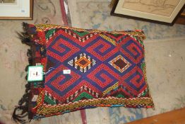 A cushion made from a ceremonial Afghan saddlebag, 30'' x 20''.