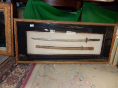 A gilded finished box frame containing a Japanese design Samurai sword and scabbard,