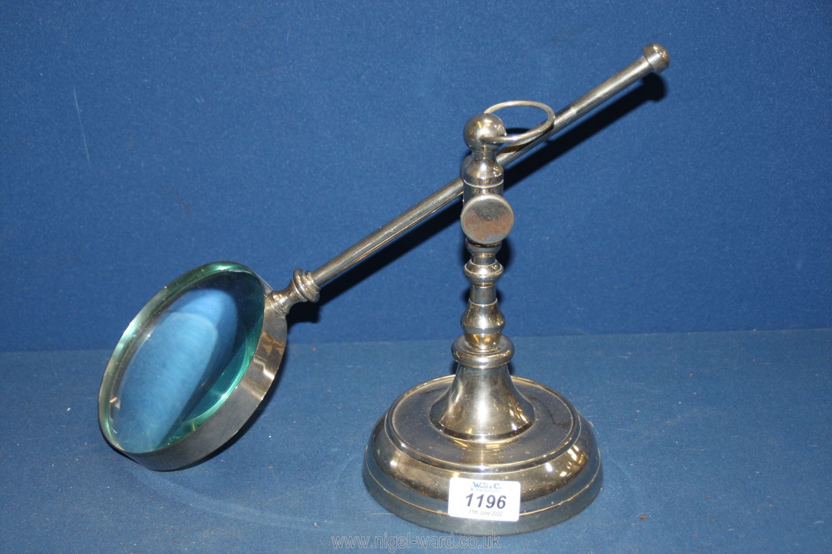 A metal magnifying glass on stand.