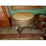 A circular Hall Centre Table having an extremely ornate gilt type finished frame,