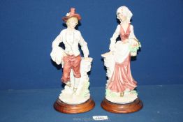 A pair of figures of a lady and gentleman, signed A. Balconi, some damage to flowers, 11 1/4'' tall.