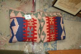 A pair of Shashevan Kilim cushions in red, blue and green, 19'' x 18''.