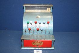 A child's metal Codeg Cash Register, 7 1/2" tall x 7 1/4" deep x 6 1/2" wide.