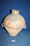 A Chinese Neolithic double handled Jar decorated in black with zig zags and stylised leaves,