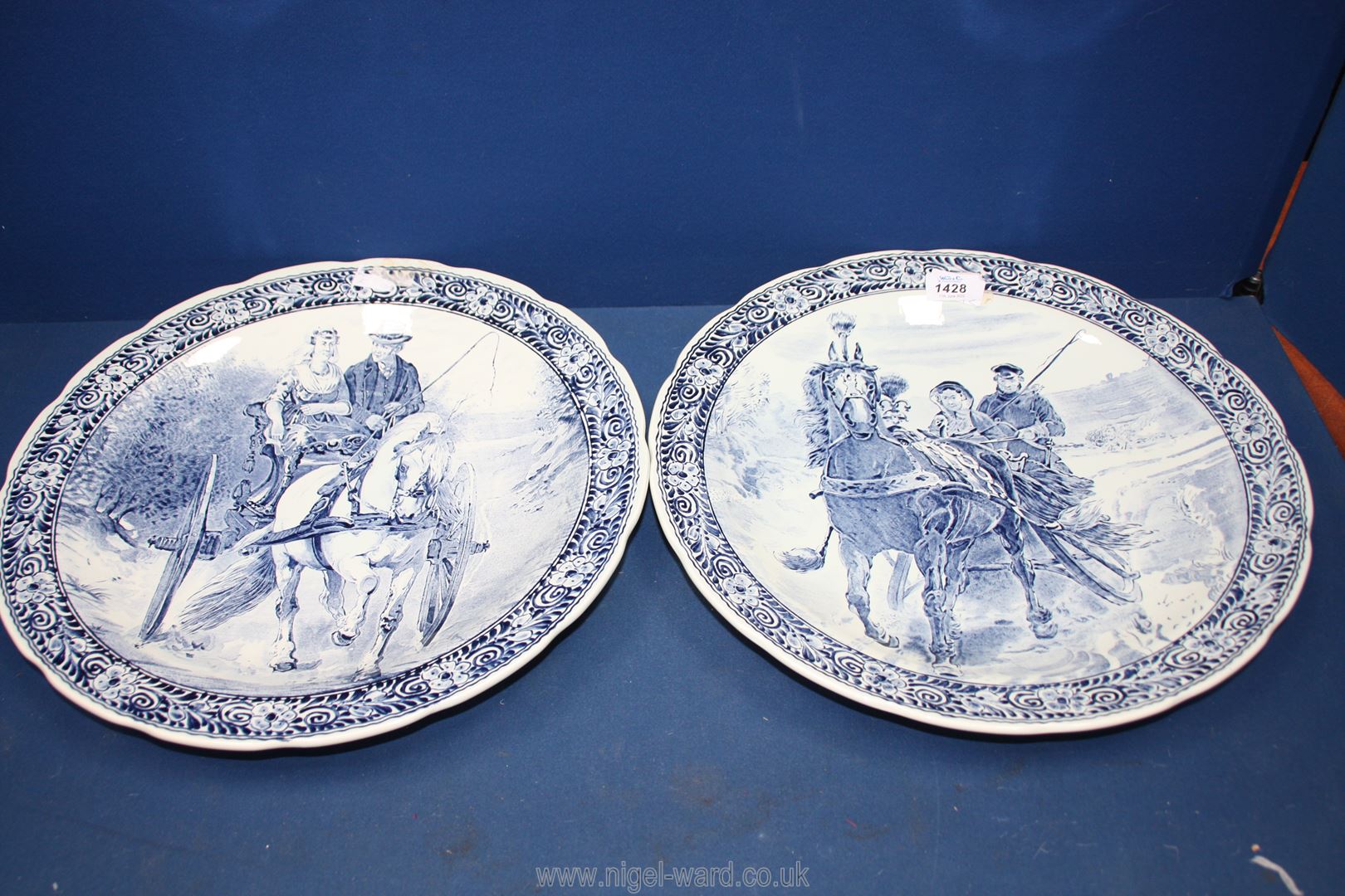 A pair of Boch Delft chargers with horse and cart scenes, 15 1/2'' diameter.