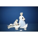 A Lladro figure of a boy sitting (shoe a/f) with two Nao ducks and one other similar.