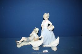 A Lladro figure of a boy sitting (shoe a/f) with two Nao ducks and one other similar.