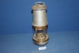 A Davy lamp by The Wolf Safety Lamp Co. (Wm Maurice) Ltd., Sheffield, No. P.O. 1973, 8 1/2" tall.