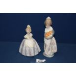 Two Lladro figures of girls, one holding oranges, 7'' tall,