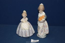 Two Lladro figures of girls, one holding oranges, 7'' tall,