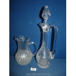 A heavy glass claret jug with stopper and pressed glass jug.