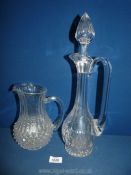 A heavy glass claret jug with stopper and pressed glass jug.