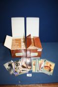 Two boxes of nostalgia postcards including entertainment, fashion, seaside, news, war,