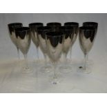 Ten glass silver lustre wine glasses.