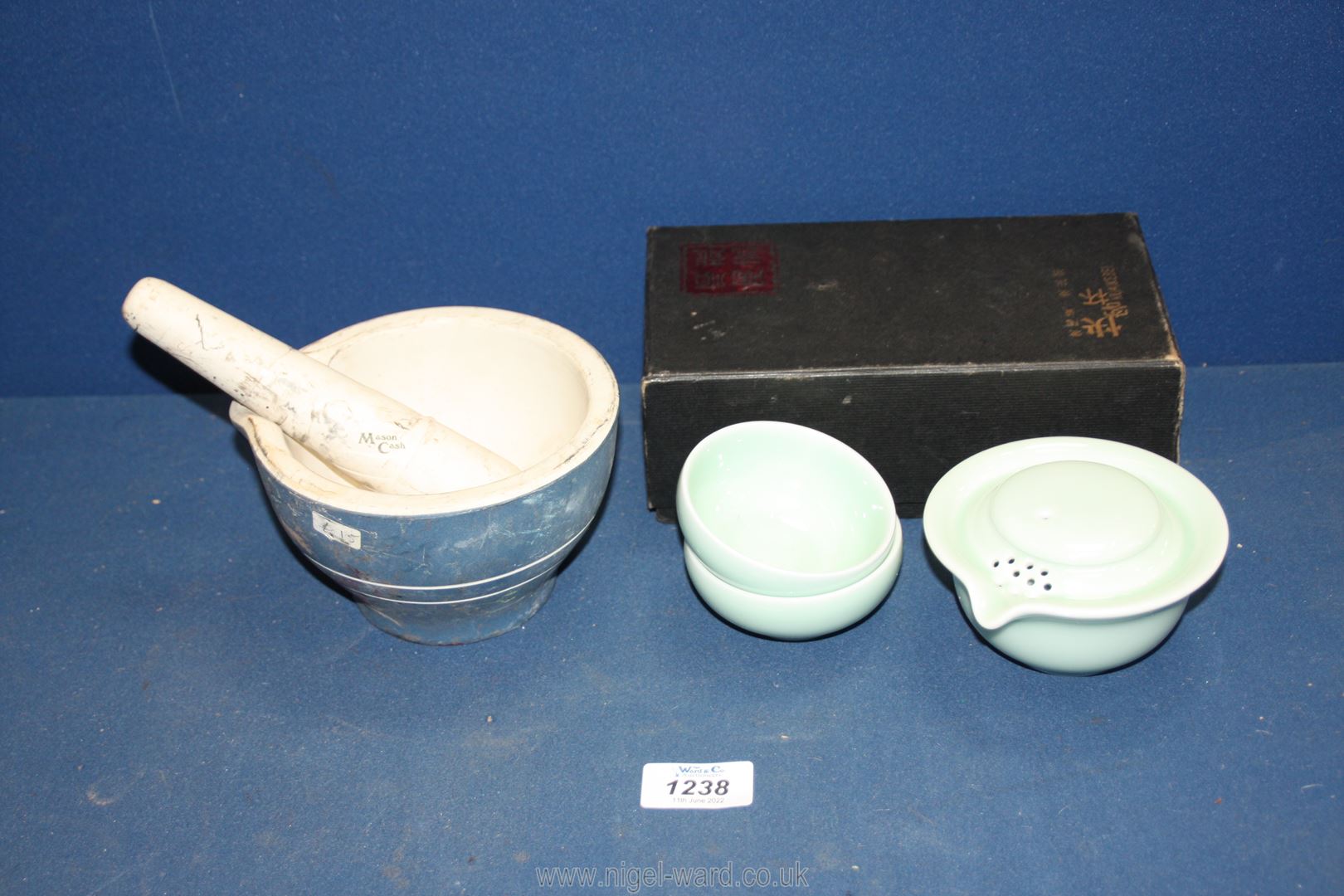 A Mason Cash pestle & mortar and a boxed Chinese teaset with teapot and two tea bowls.