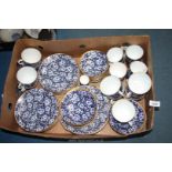 A good quantity of china in allover blue and white blossom design with gilt rim including,